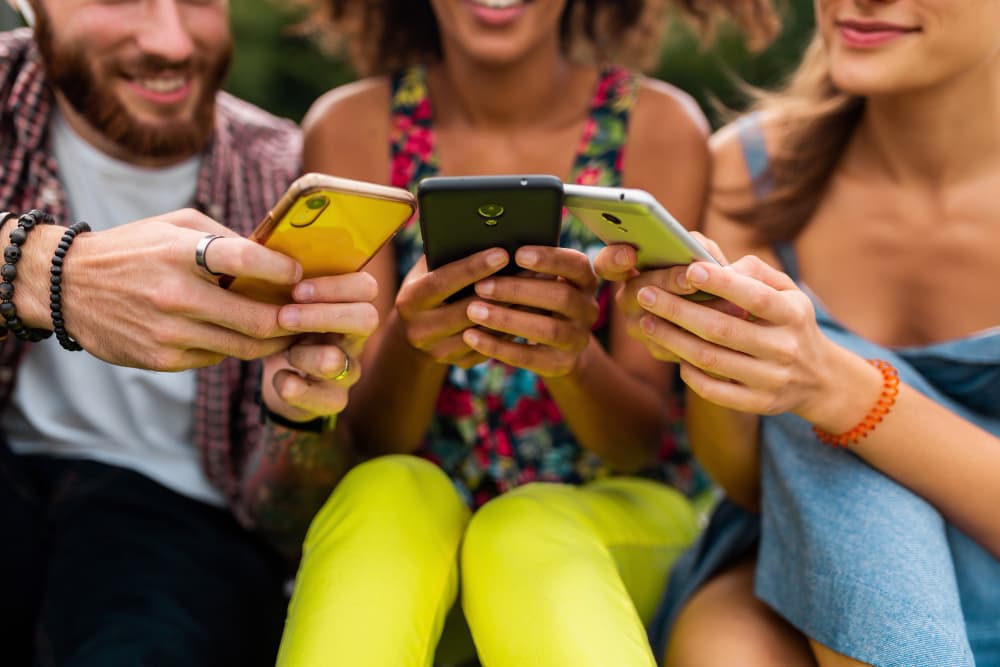 People sharing and viewing content on their phones