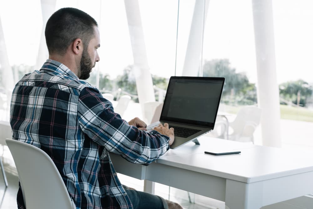 Professional building a digital business card on a laptop